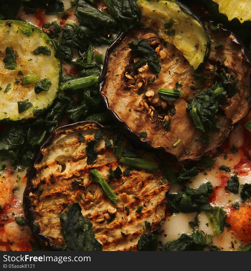 Detailed of vegetarian Pizza with mozzarella, tomato, zucchini and eggplant.