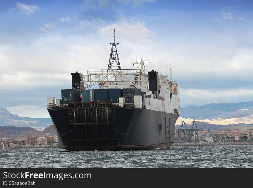 General cargo ship sailing close to the coast