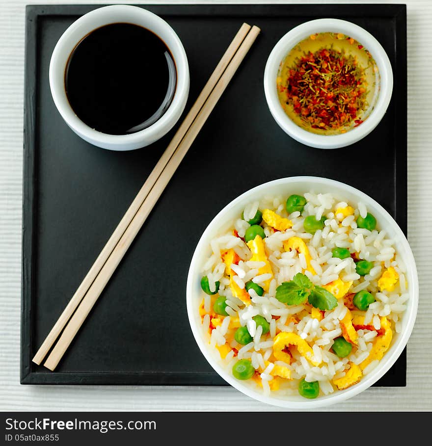 Bowl of fried rice, peas and egg with oyster sauce and aromatic oil