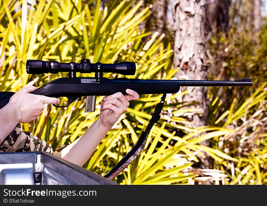 Teenage girl hunting with .22 rifle. Teenage girl hunting with .22 rifle.