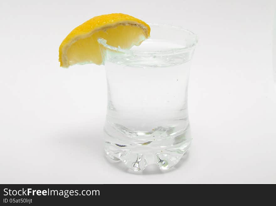 Tequila shot with salt andlemon on white background. Tequila shot with salt andlemon on white background