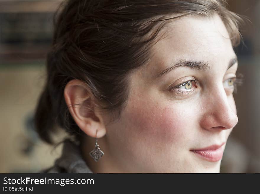 Portrait of a young woman looking away from the camera. Portrait of a young woman looking away from the camera