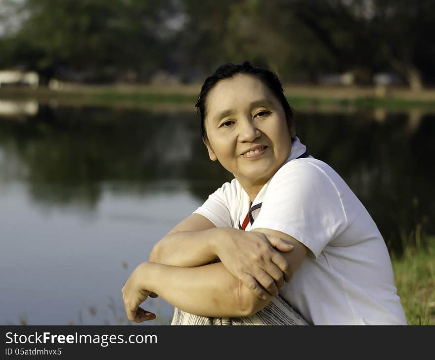 Portrait of happy asian woman in the park