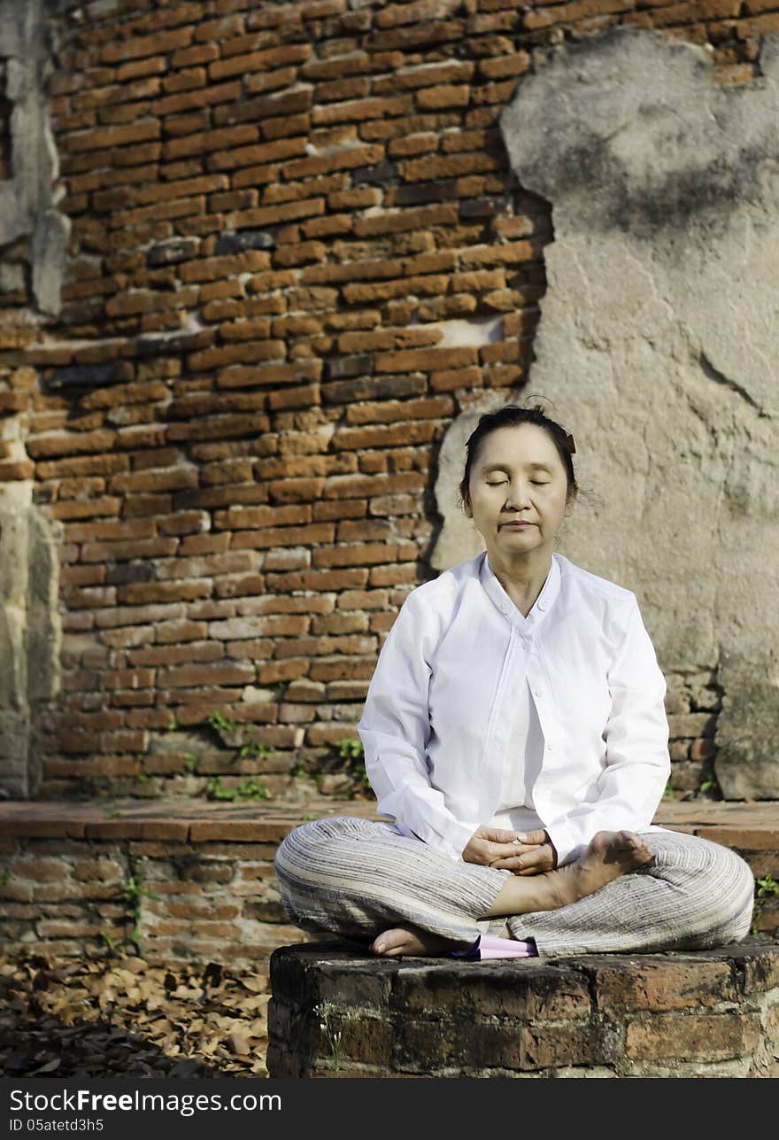 Woman meditating in temple