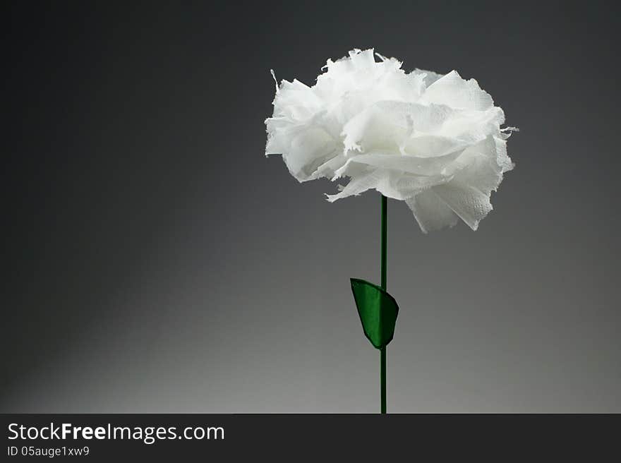 Flower of white paper with green leaf