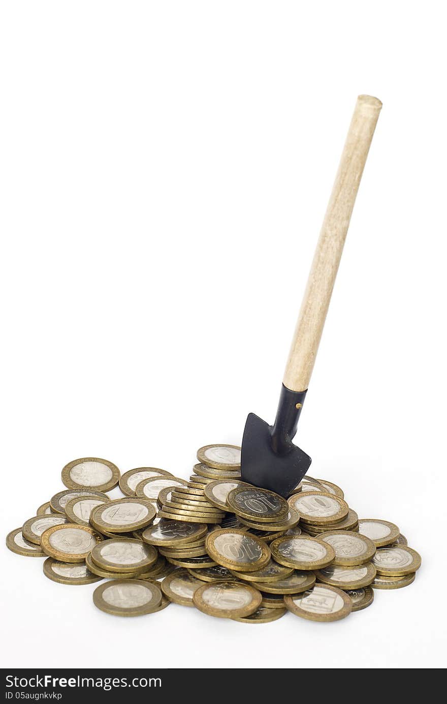 Metal money and shovel on white background. Metal money and shovel on white background