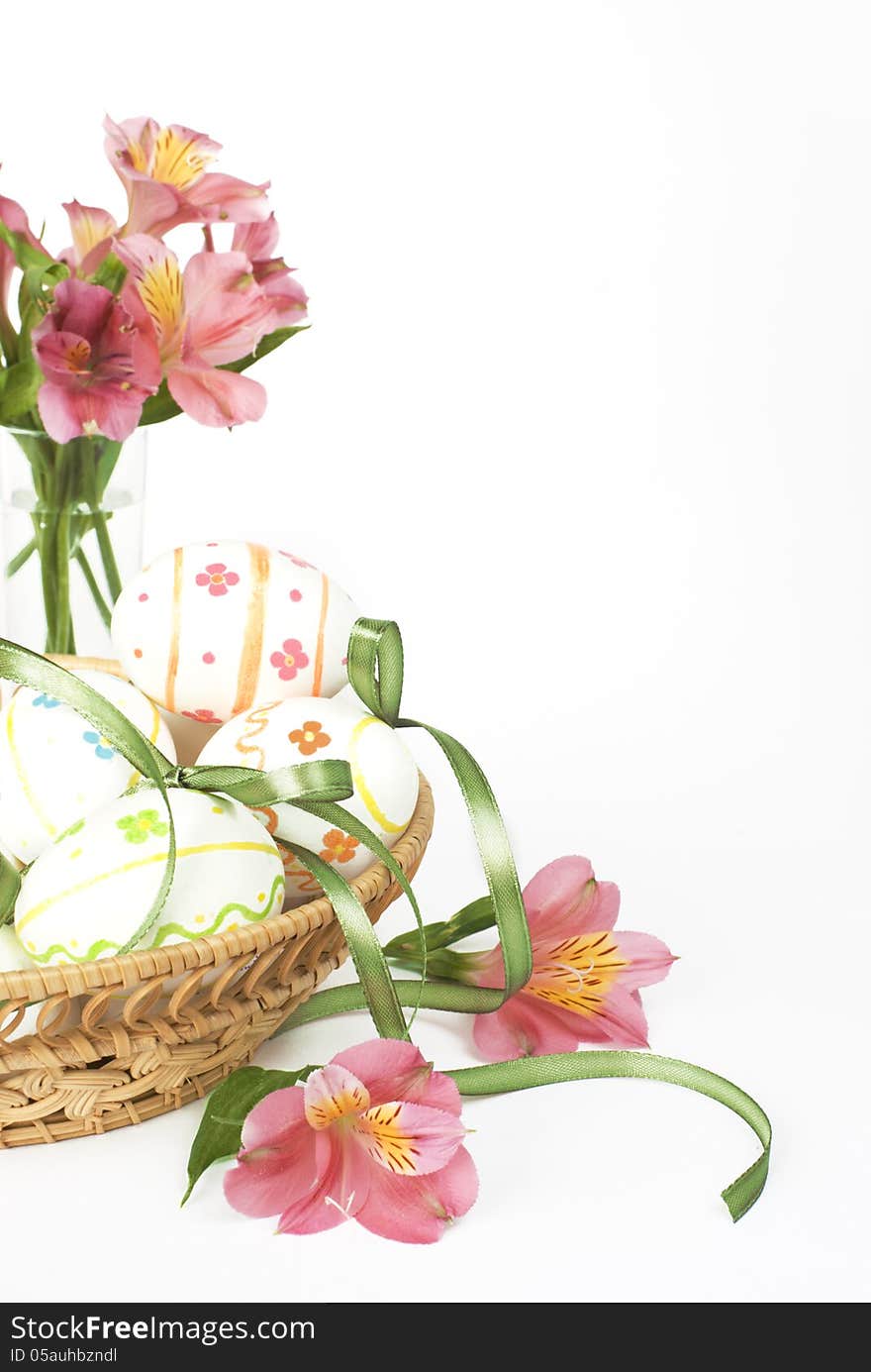 Easter eggs with pink flowers in a wicker basket