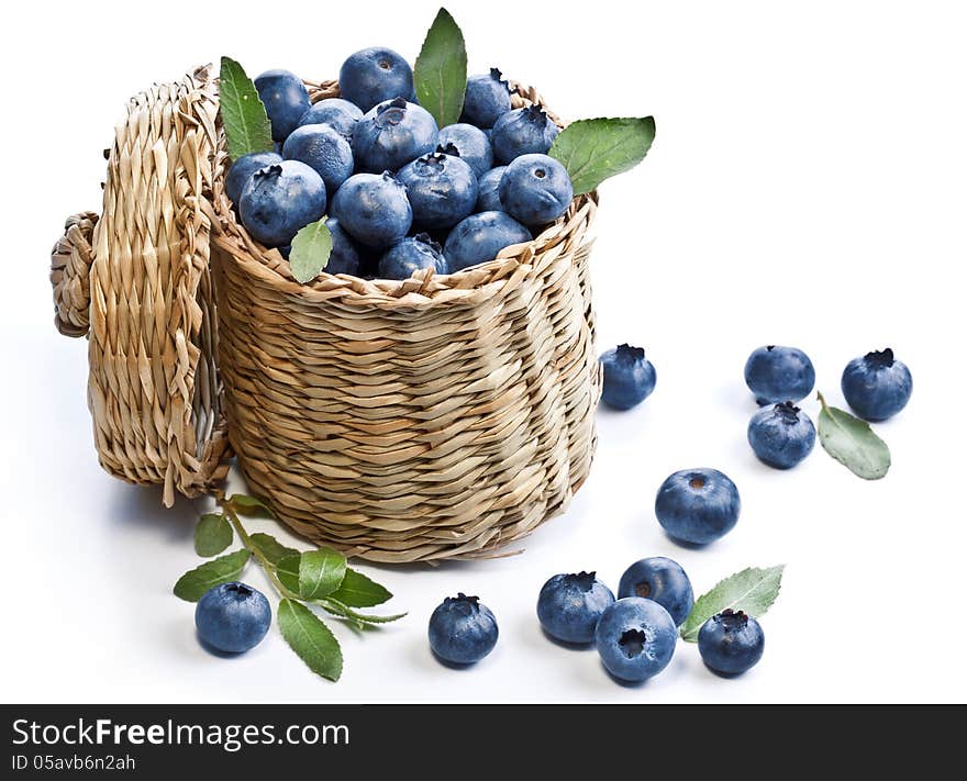 Blueberries in a basket on a white background.