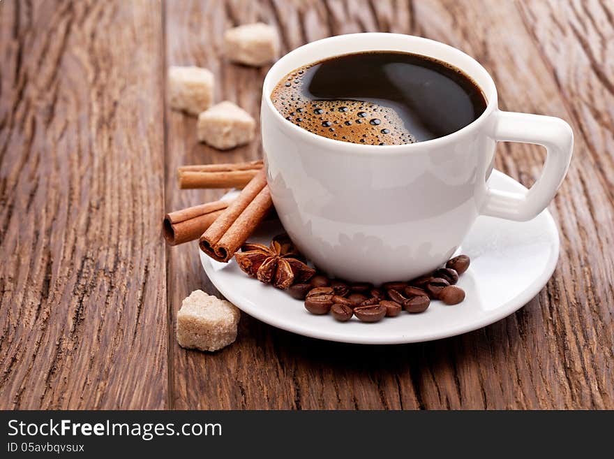 Cup of coffee with brown sugar on a wooden table. Cup of coffee with brown sugar on a wooden table.