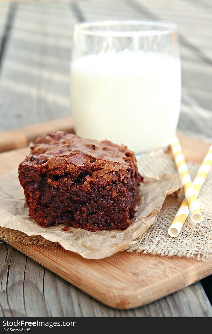 Thick chocolate brownies with a glass of milk. Thick chocolate brownies with a glass of milk.