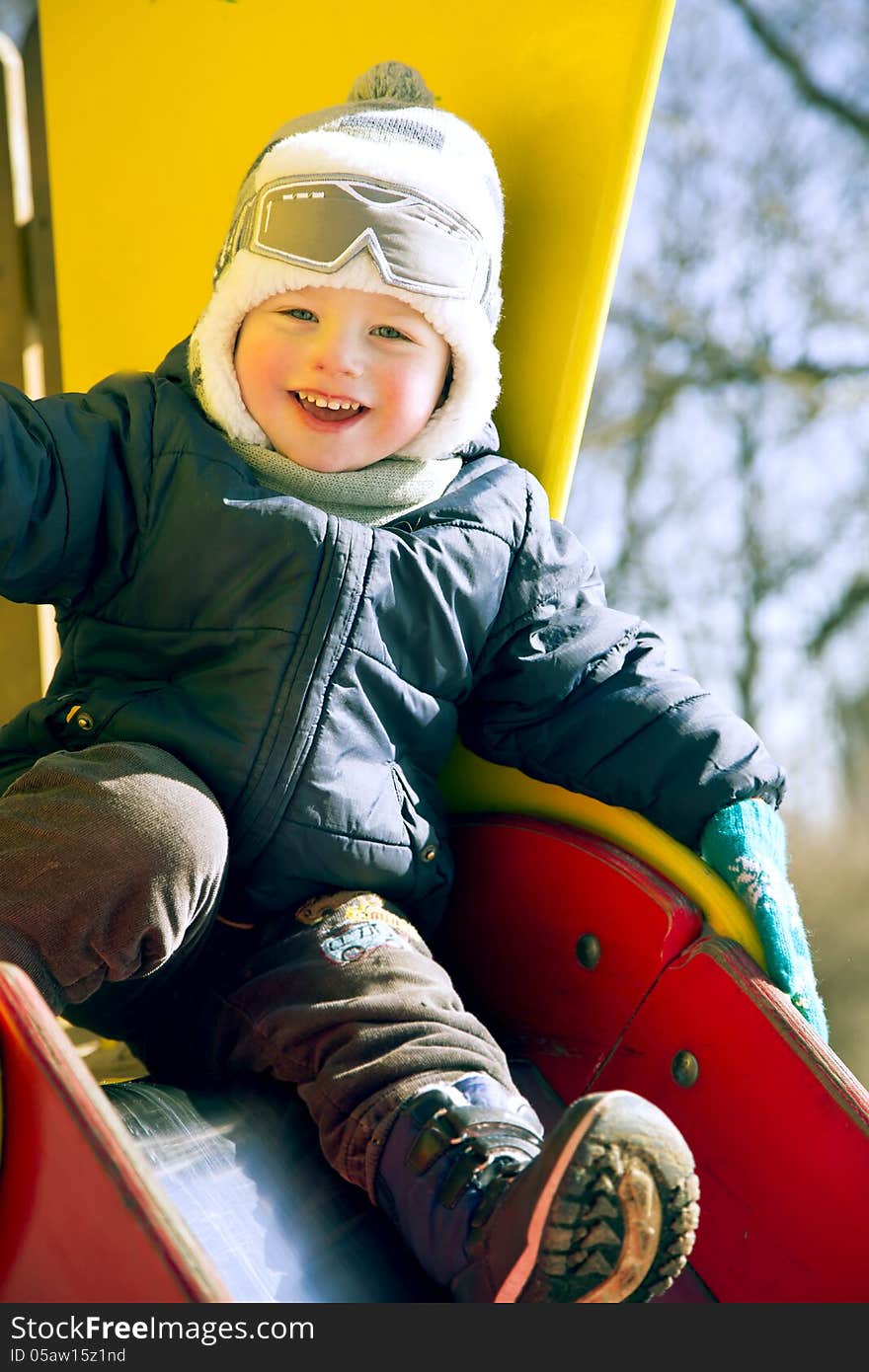 Happy smiling boy on children playground