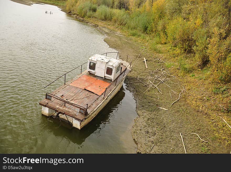 Old boat on the water near the shore. Old boat on the water near the shore.