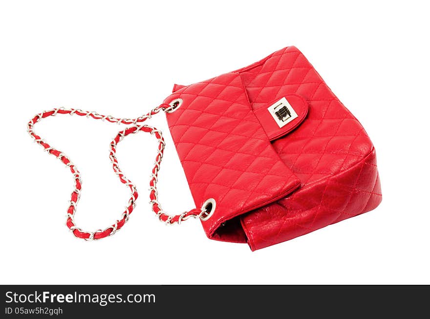 Female handbag of red colour isolated on a white background