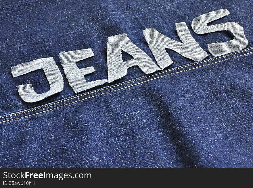 The words jeans on the jeans background. The words jeans on the jeans background.