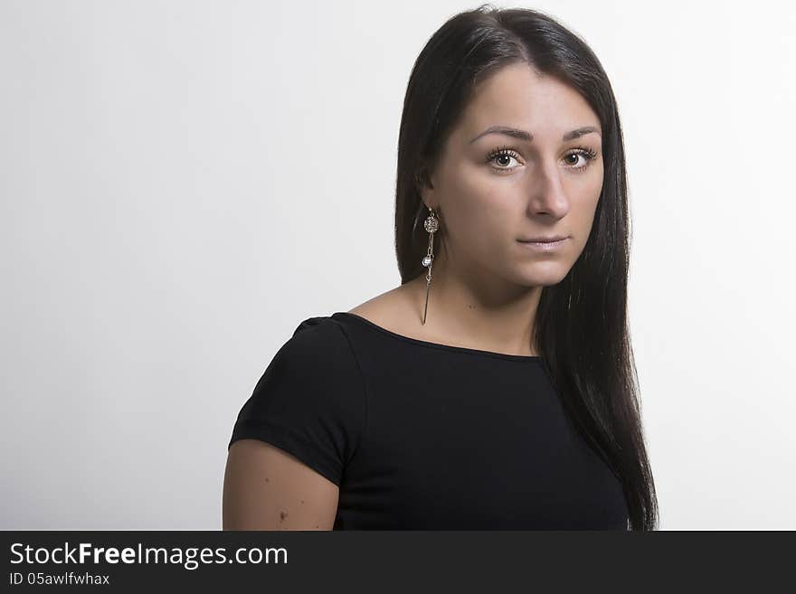 Portrait of young woman in black t-short with earring. Portrait of young woman in black t-short with earring