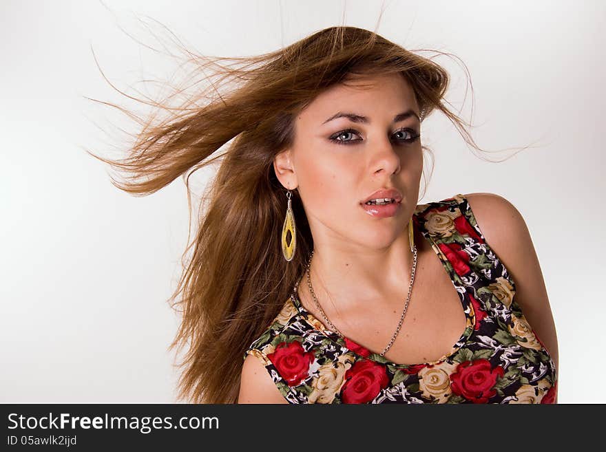 Portrait of a girl with her hair on a white background.