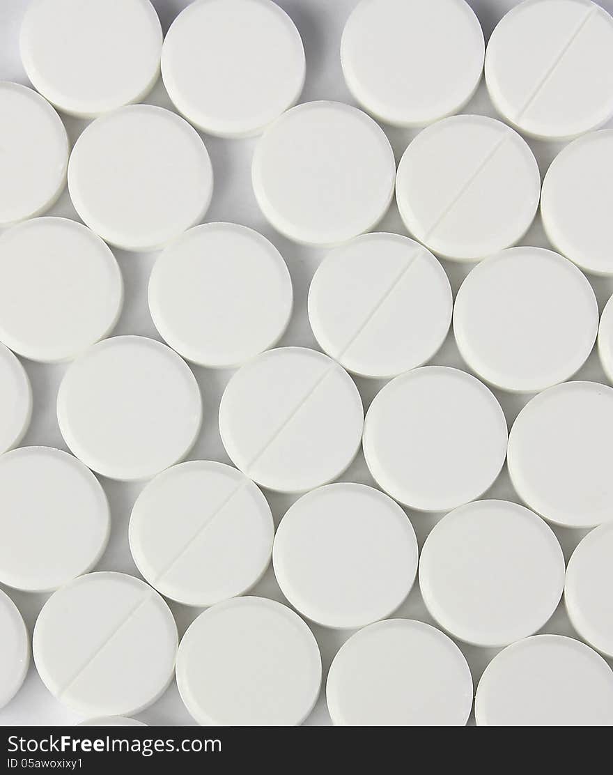 Many of white round pills