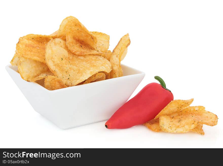 Chili potato crisp snacks in a porcelain dish with red pepper over white background. Chili potato crisp snacks in a porcelain dish with red pepper over white background.