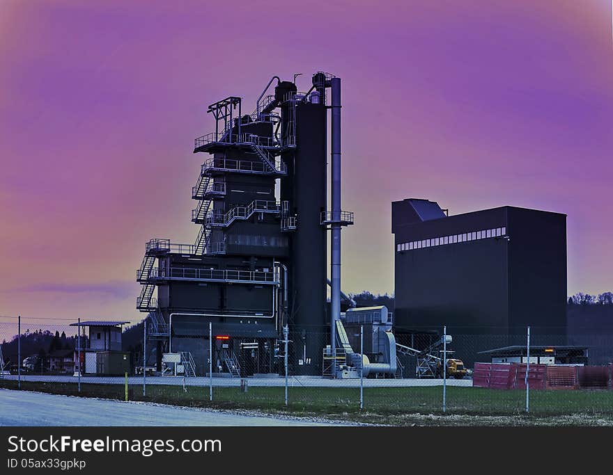 A factory in the blue hour just after sunset with the colorful sky. A factory in the blue hour just after sunset with the colorful sky.