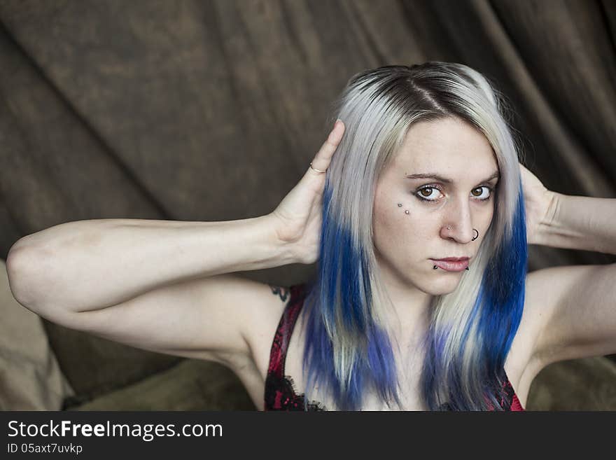 Portrait of a beautiful young woman with blue hair.