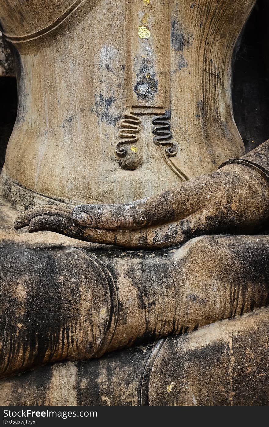 Detail of hand of stone sitting Buddha in Sukhothai historical park, Thailand