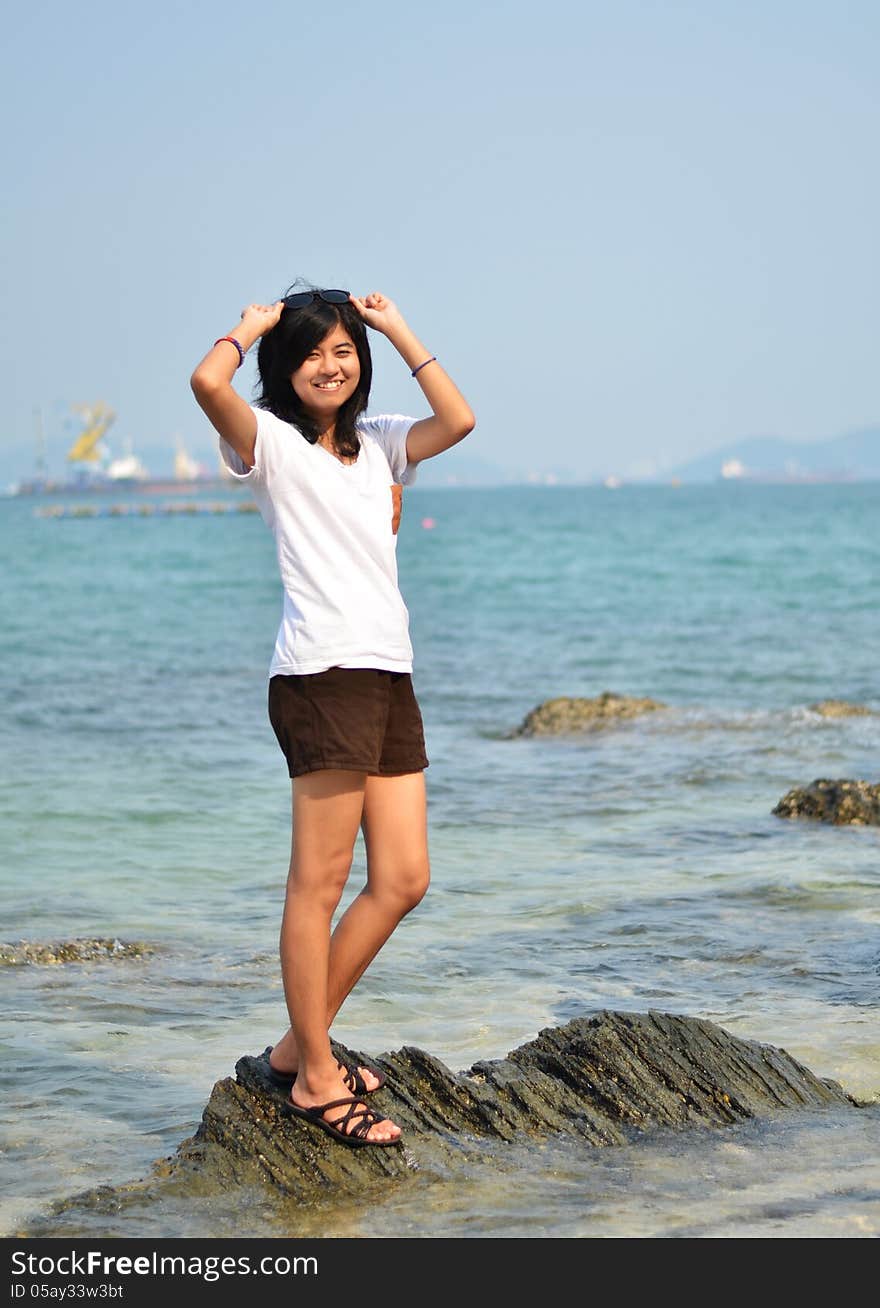 Beautiful Asian girl smiling at the beach