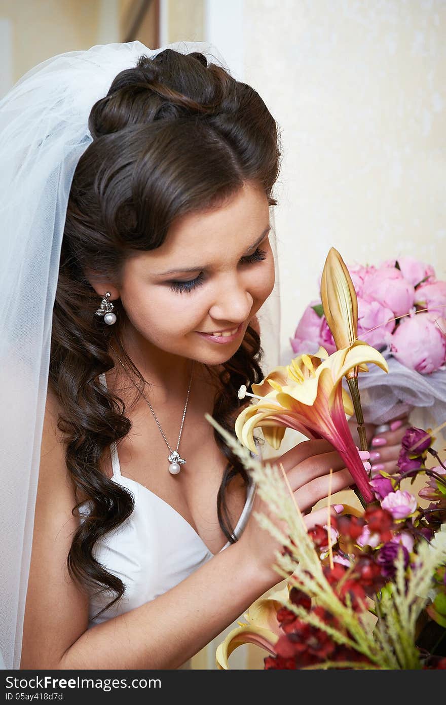 Happy bride with flowers in wedding day