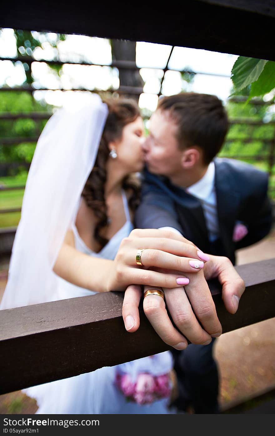 Romantic kiss bride and groom in wedding walk