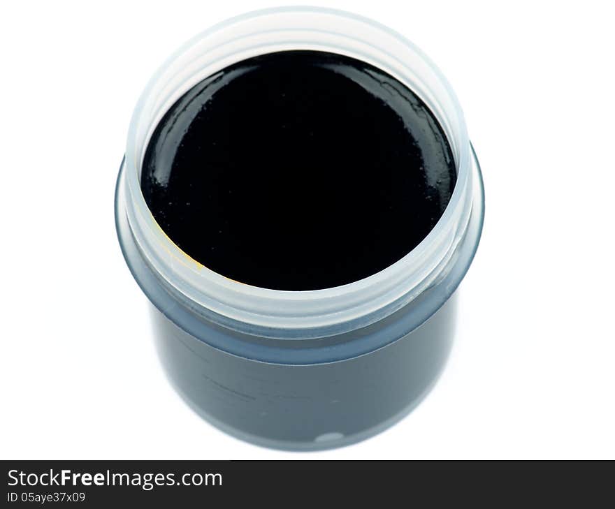 Container with Black Gouache Paint isolated on white background. Top View