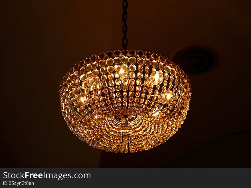 Ancient glass chandelier isolated over black background. Ancient glass chandelier isolated over black background