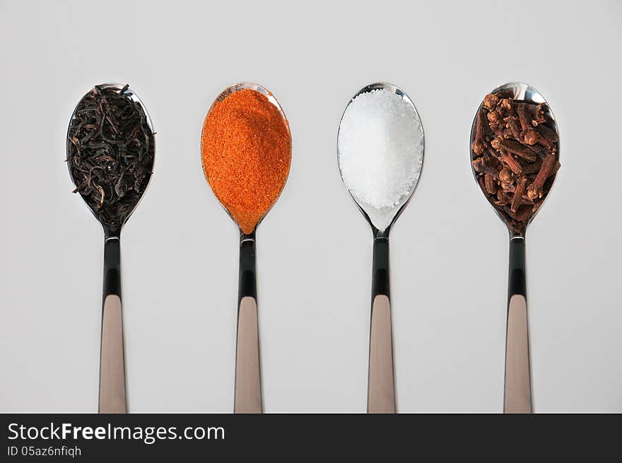 Spoons with various spices, arranged in series. Spoons with various spices, arranged in series