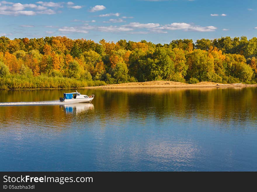 Ship On River. Autumn forest background