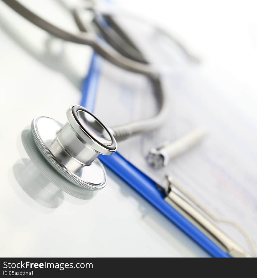 Stethoscope with blue medical clipboard