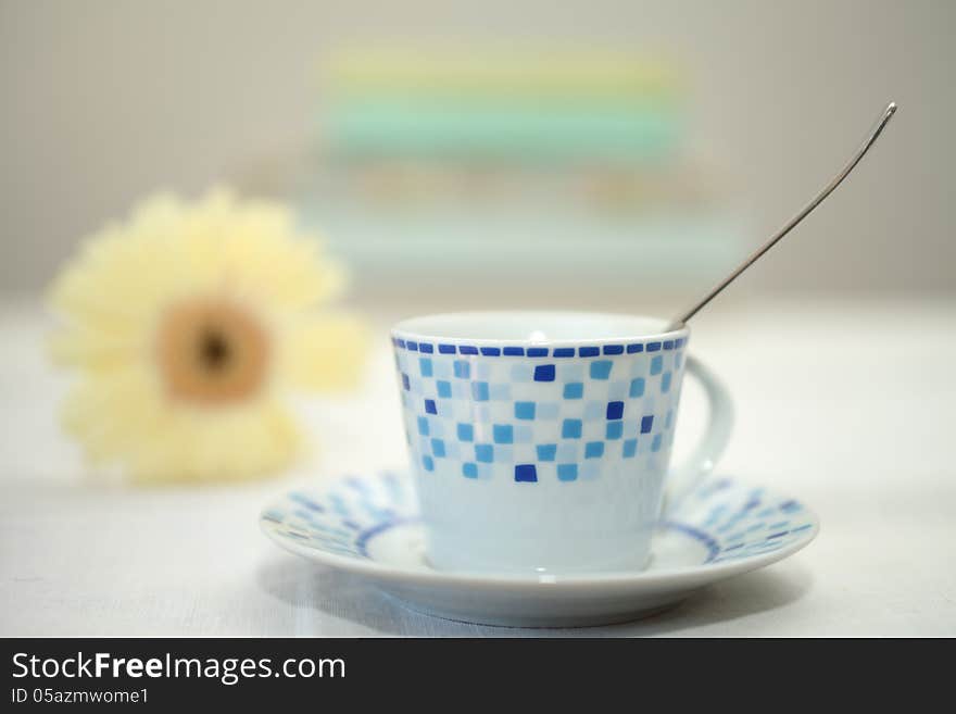 A cup of coffee with a flower.