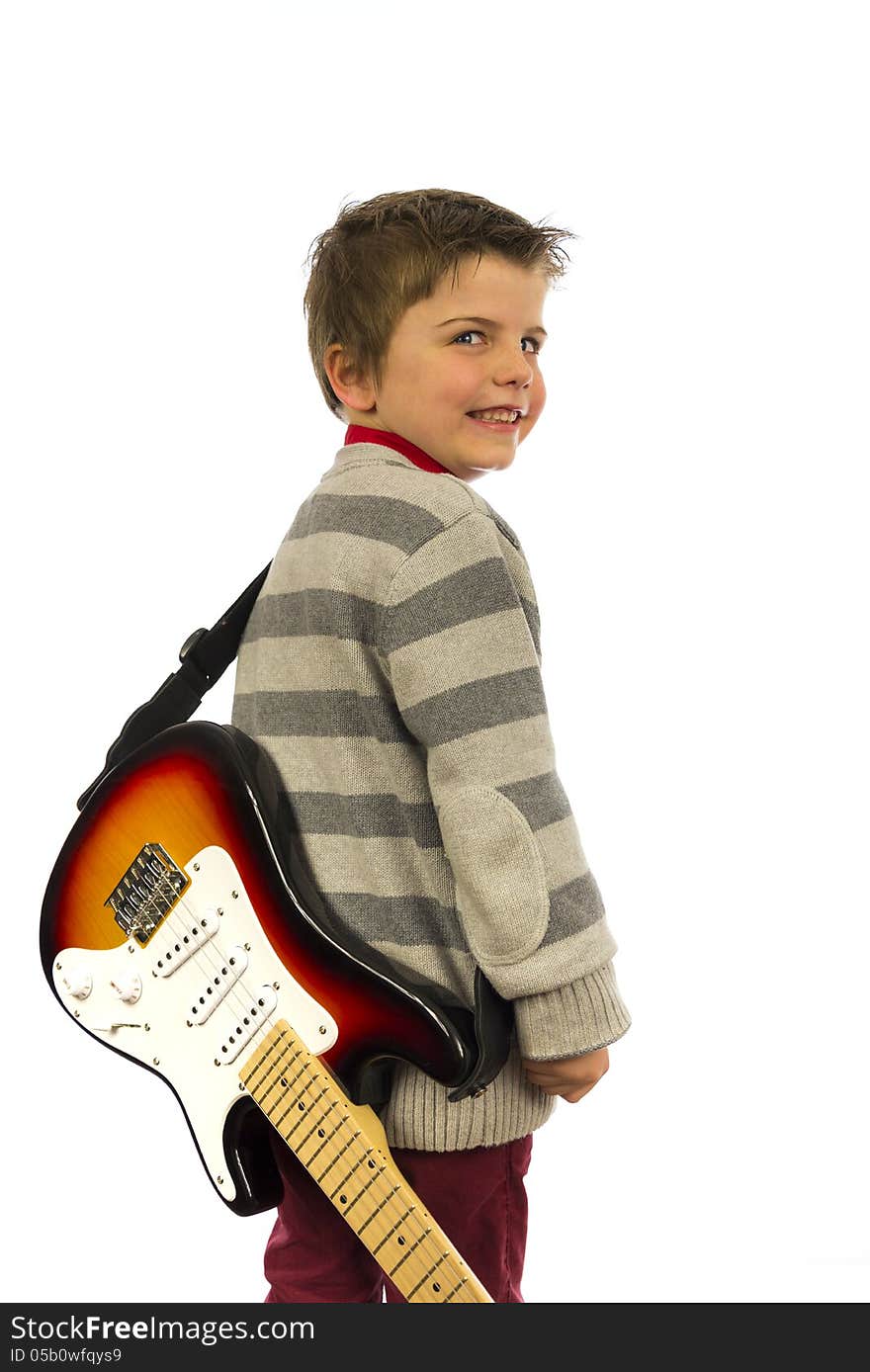 Boy with guitar on his back looking over shoulder. Boy with guitar on his back looking over shoulder.