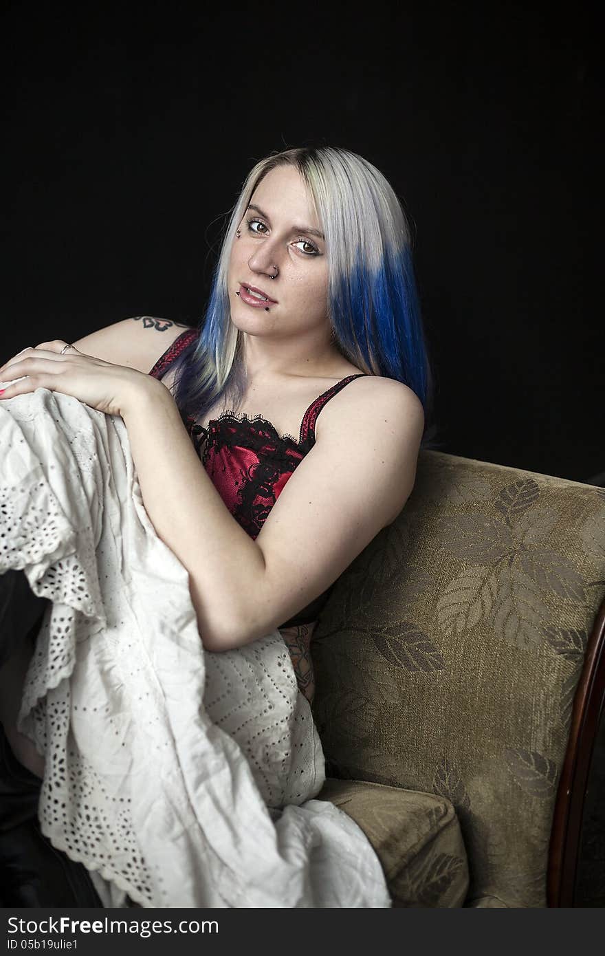 Portrait of a beautiful young woman with blue hair, white skirt, and red corset. Portrait of a beautiful young woman with blue hair, white skirt, and red corset.