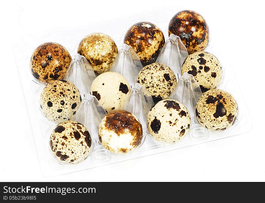 Fresh quail eggs in a transparent box. Image taken over white background. Fresh quail eggs in a transparent box. Image taken over white background.