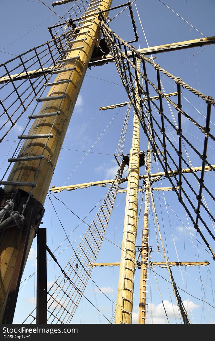 Wooden mast ship on a background of blue sky. Wooden mast ship on a background of blue sky.