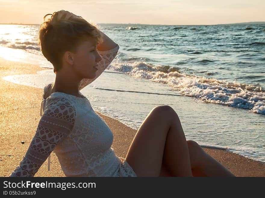 girl at summer sea beach looking to the sea. girl at summer sea beach looking to the sea