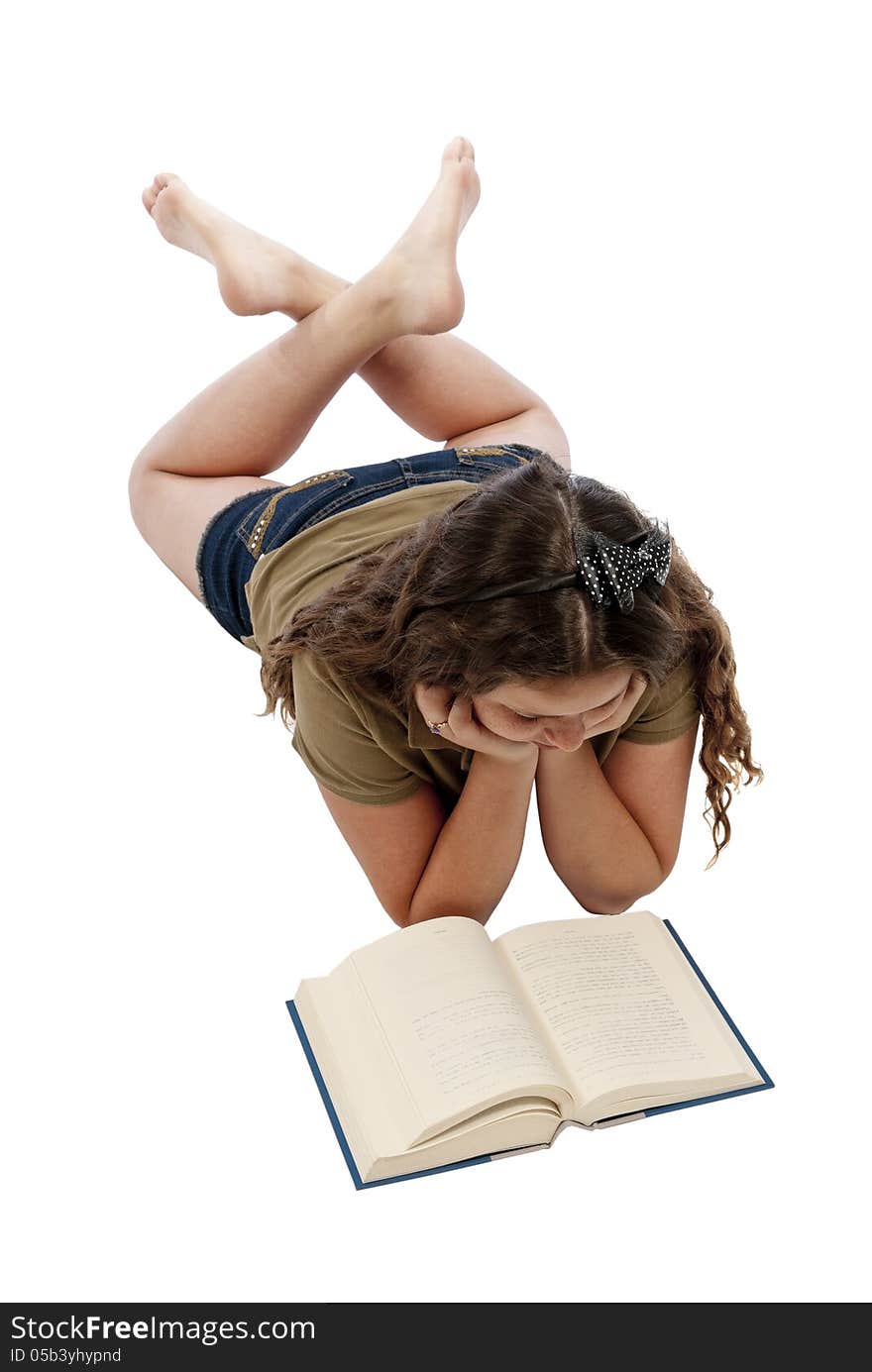 Young teenage girl lying down resting while reading and studying with her legs crossed. Isolated on a white background. Vertical shot. Young teenage girl lying down resting while reading and studying with her legs crossed. Isolated on a white background. Vertical shot.