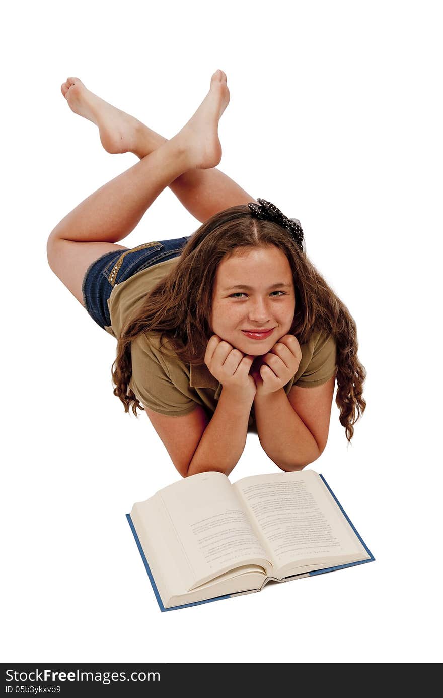 Young teenage girl posing and smiling while reading her book. Vertical shot, isolated on a white background. Studio. Young teenage girl posing and smiling while reading her book. Vertical shot, isolated on a white background. Studio.