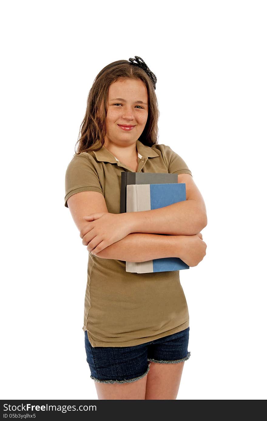 Vertical shot of a young teenage girl holding books and smiling while posing on a white background. Shot in studio. Vertical shot of a young teenage girl holding books and smiling while posing on a white background. Shot in studio.