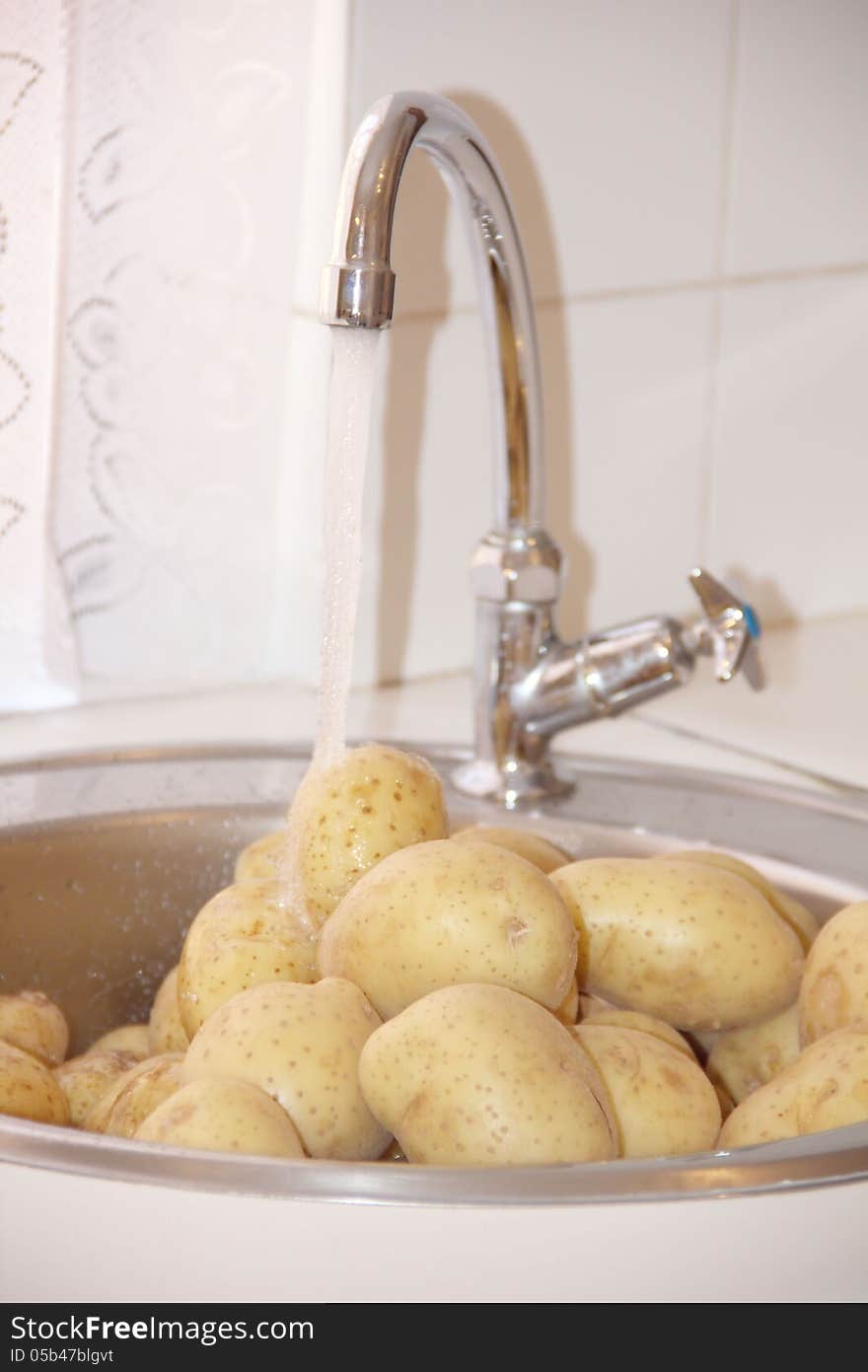 Fresh clean potatoes in a kitchen sink