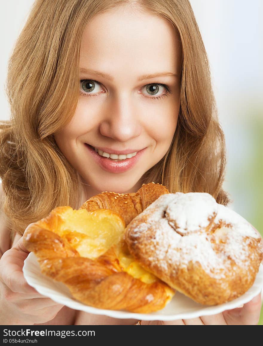 Happy young woman offers treats cakes, scones, muffins, biscuits