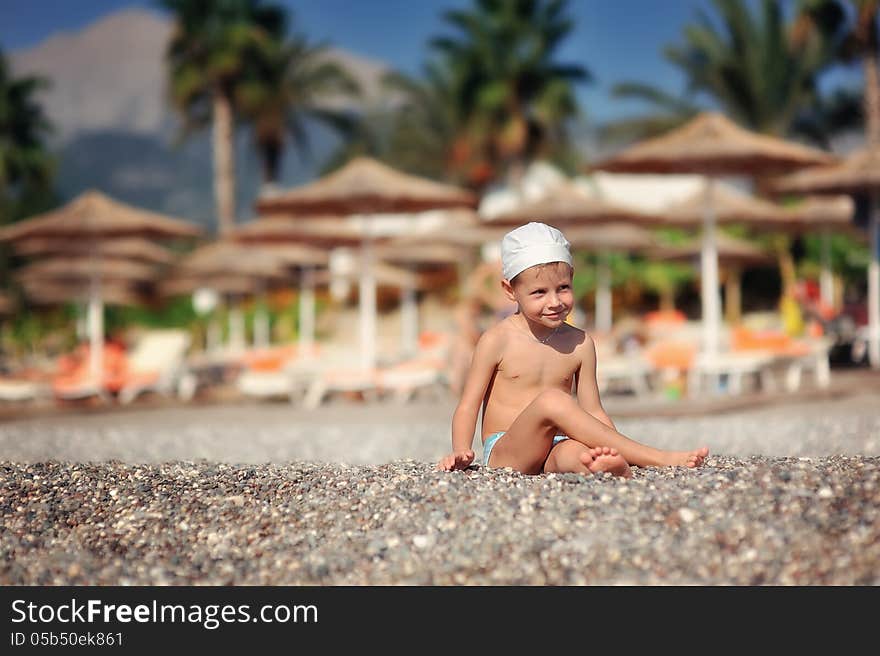 The child on the sea in a hat has a rest in the summer. The child on the sea in a hat has a rest in the summer