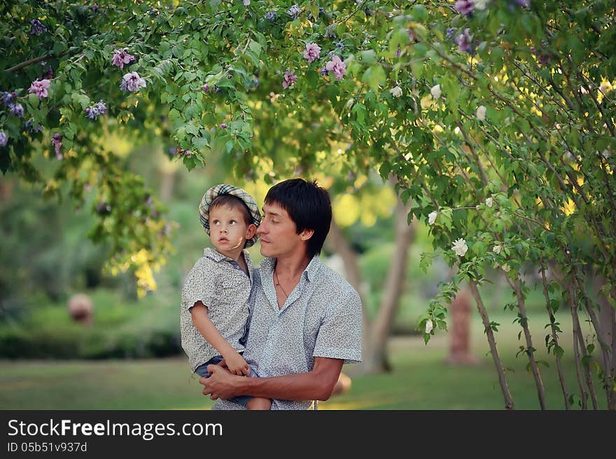 In the park summer day, father and son hugging. In the park summer day, father and son hugging