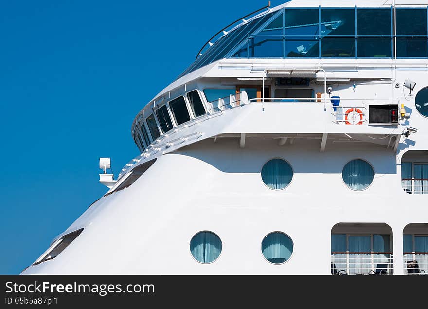 View from the upper deck of a cruise ship. Captain's bridge on the luxury ocean liner. Seaside of the white passenger ship with portholes.