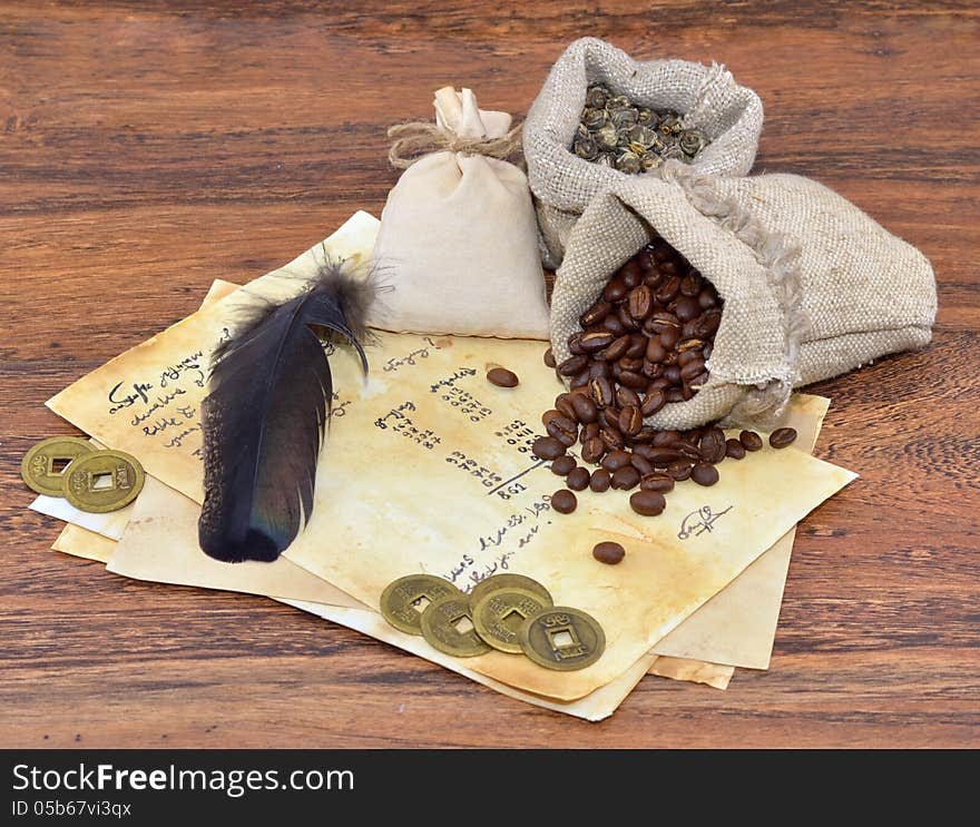 Old vintage letter with feather and coffee in burlap sacks. Old vintage letter with feather and coffee in burlap sacks