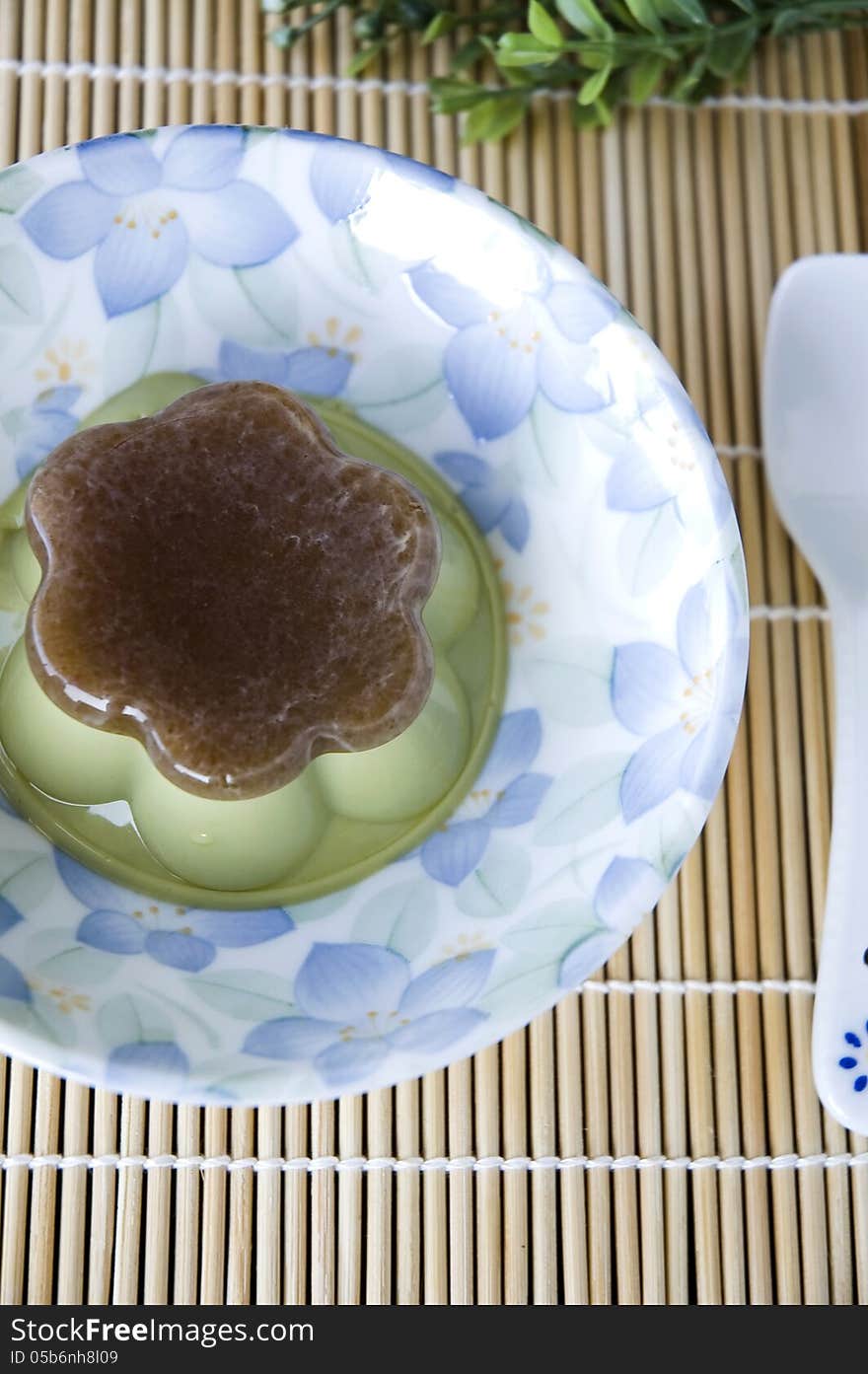 Matcha green tea pudding on plate with spoon. Matcha green tea pudding on plate with spoon