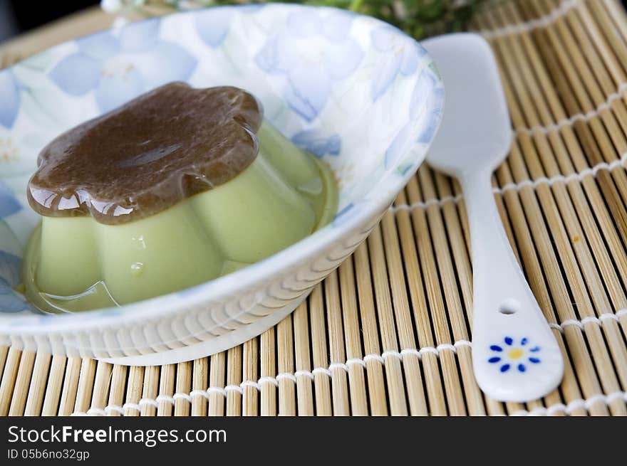 Pudding green tea dessert serve on plate with spoon